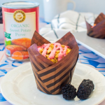 Blackberry sweet potato muffin with a can of Farmer's Market Foods Organic Sweet Potato Puree in the background