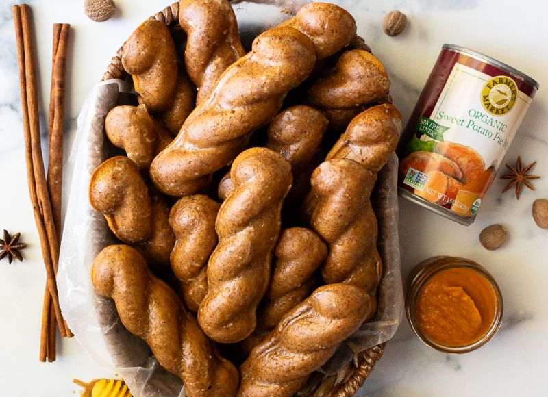 a full platter of gluten-free sweet potato donut twists with a can of Farmer's Market Foods Organic Sweet Potato Pie Mix