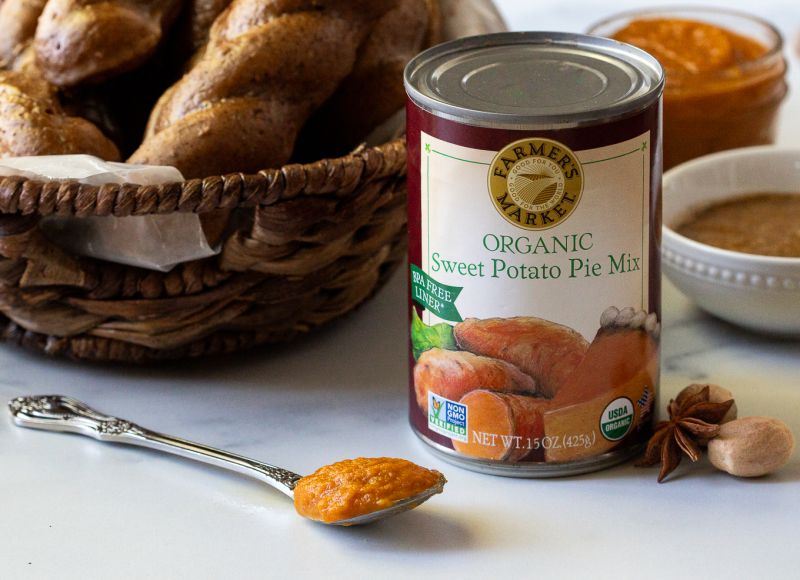 A can of Farmer's Market Foods Organic Sweet Potato Pie Mix with a spoonful of the pie mix