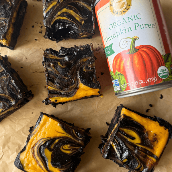 cut pumpkin cheesecake bars with a can of Farmer's Market Foods Organic Pumpkin Puree