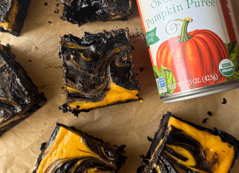 cut pumpkin cheesecake bars with a can of Farmer's Market Foods Organic Pumpkin Puree