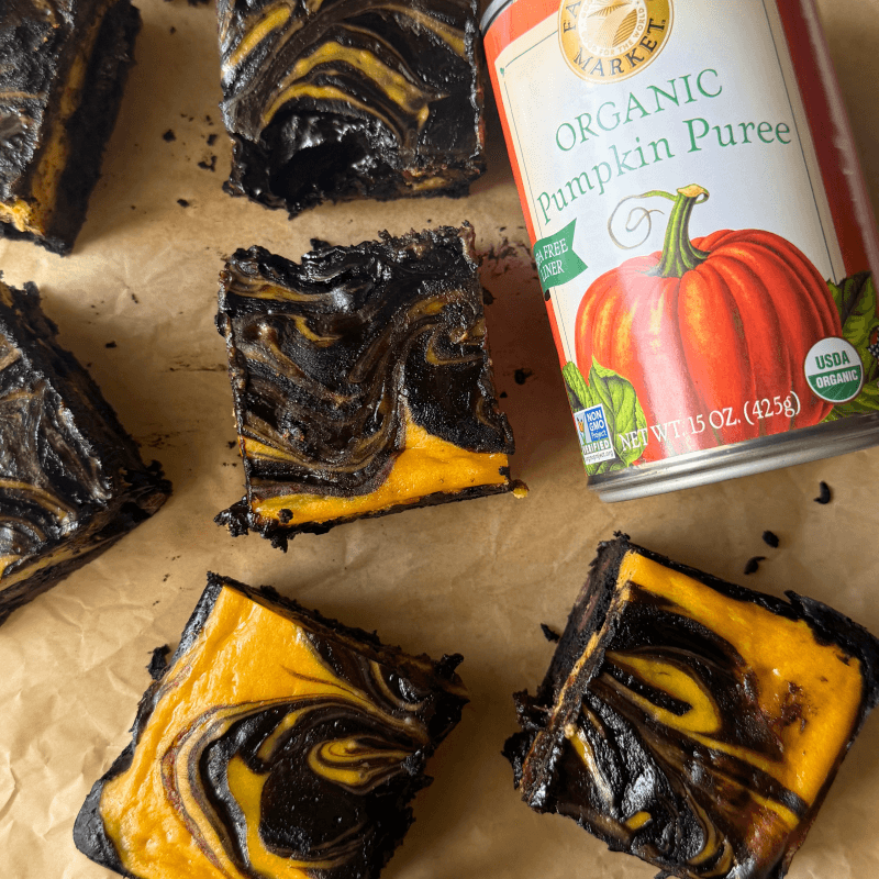cut pumpkin cheesecake bars with a can of Farmer's Market Foods Organic Pumpkin Puree