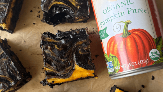 cut pumpkin cheesecake bars with a can of Farmer's Market Foods Organic Pumpkin Puree
