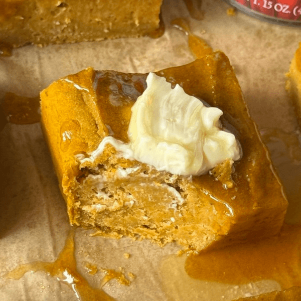a slice of pumpkin brown butter cornbread with a bite taken out