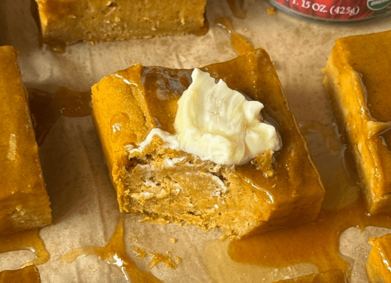 a slice of pumpkin brown butter cornbread with a bite taken out