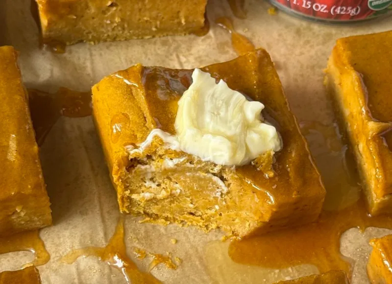 a slice of pumpkin brown butter cornbread with a bite taken out