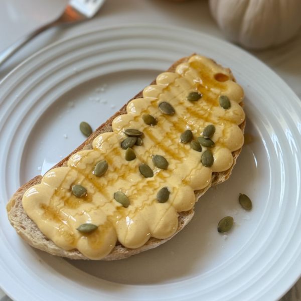 a slice of hot honey sourdough toast with a whipped pumpkin cottage cheese spread