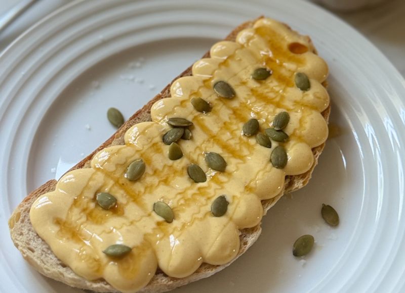 a slice of hot honey sourdough toast with a whipped pumpkin cottage cheese spread