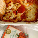 a dish of pumpkin pizza dip with a can of Farmer's Market Foods Organic Pumpkin Puree