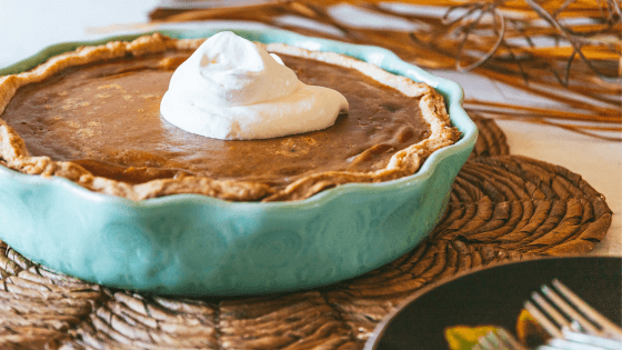 a whole pumpkin pie with whipped cream