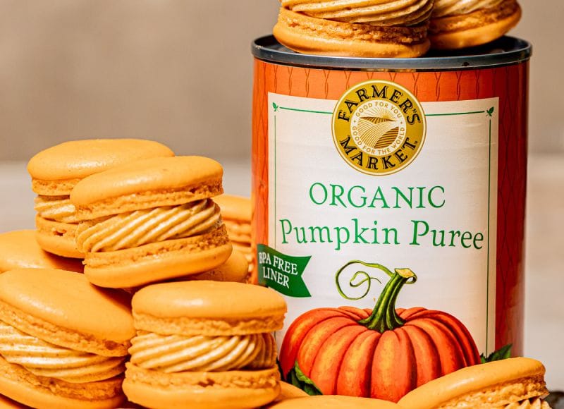 a stack of pumpkin spice macarons next to a can of Farmer's Market Foods Organic Pumpkin Puree