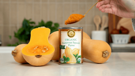 a photo of someone scooping out a scoop of canned butternut squash puree